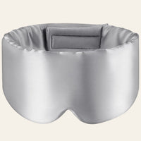 Masque de sommeil en soie gris, présenté de face sur fond clair.