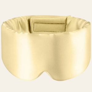 Masque de sommeil en soie beige, présenté de face sur fond clair.
