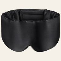 Masque de sommeil en soie noir vu de face, avec sa fermeture intérieure visible.